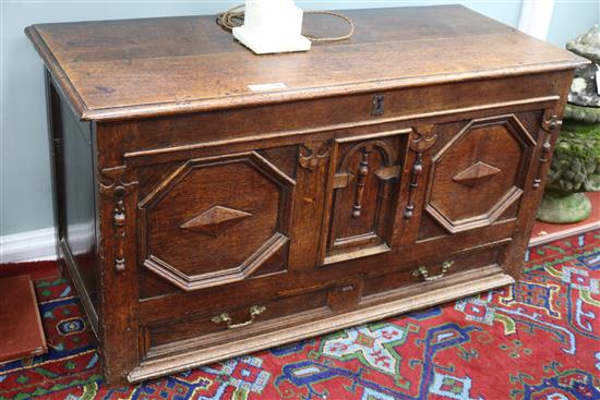 An early 18th century oak coffer, with later geometric decoration, W.4ft 4in.